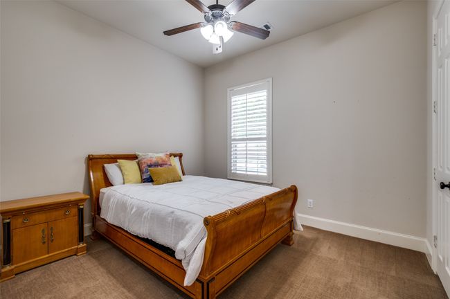 Bedroom featuring light colored carpet and a ceiling fan | Image 24