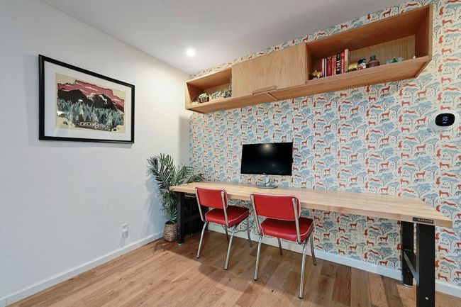 The built-in desk area features a Hygge & West Serengeti Wallpaper accent wall. | Image 8