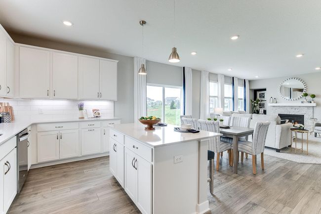 The signature kitchen in the Jordan floorplan is beautifully designed & includes quartz countertops, tile backsplash, double wall ovens & a huge walk-in pantry. | Image 8