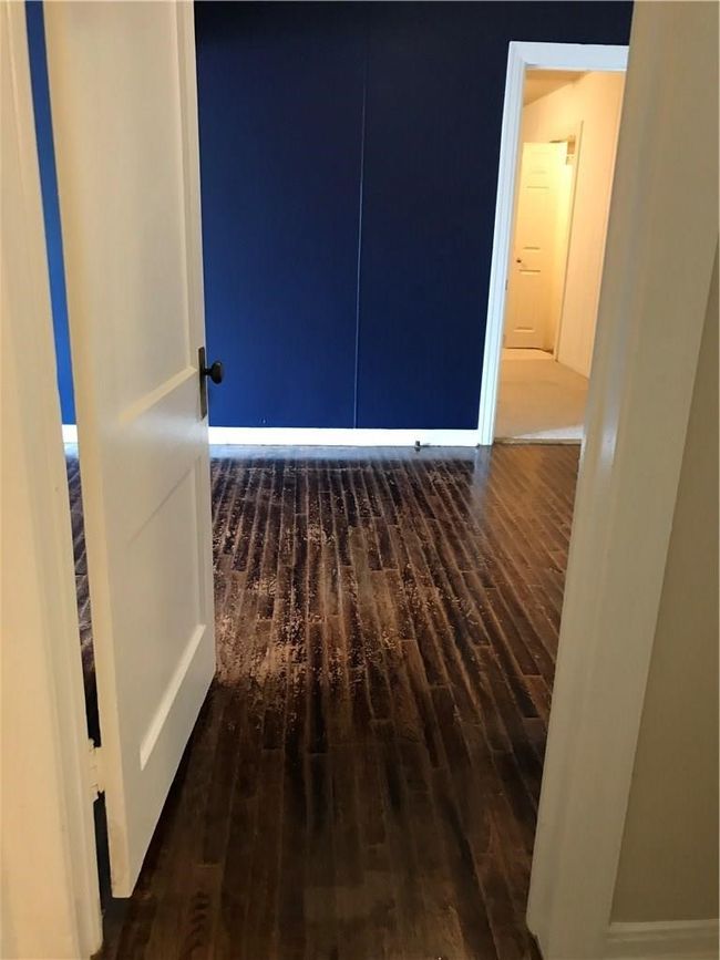 Unfurnished room featuring wood finished floors and baseboards | Image 6