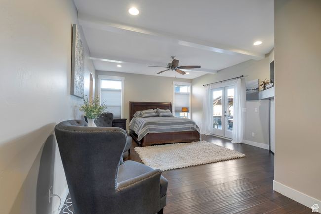 Bedroom with baseboards, dark wood-style flooring, beam ceiling, recessed lighting, and french doors | Image 29