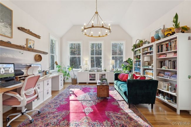 Office area with a chandelier, wood finished floors, and vaulted ceiling | Image 16