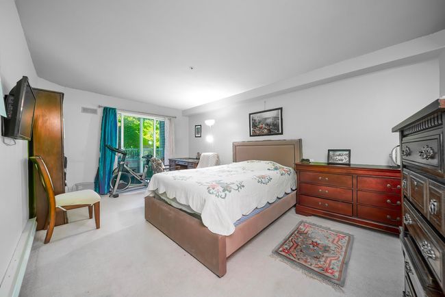 Bedroom featuring access to exterior and light carpet | Image 16