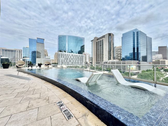 View of pool with a view of skyline | Image 31