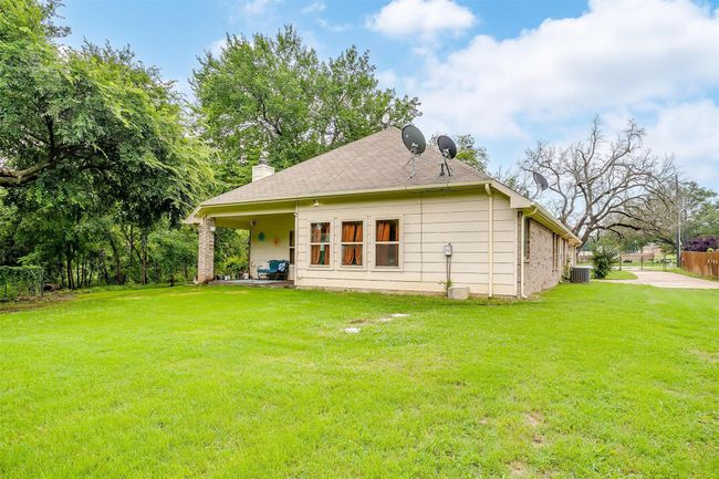 Back of house with a chimney and a patio area | Image 33