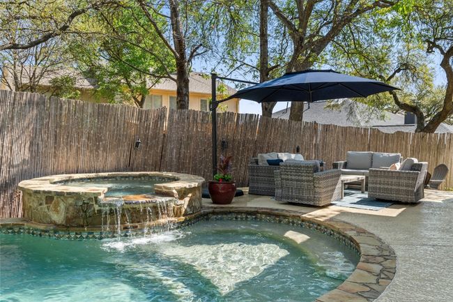 View of swimming pool with an outdoor living space, a fenced backyard, a patio, and a pool with connected hot tub | Image 36