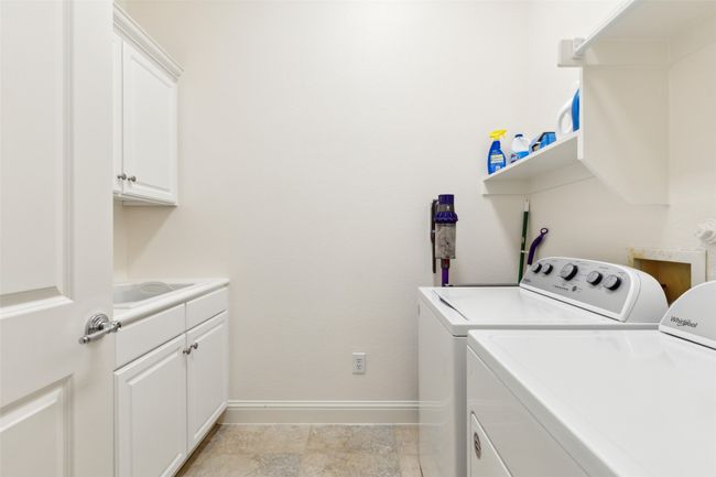 Utility room complete with sink. | Image 24