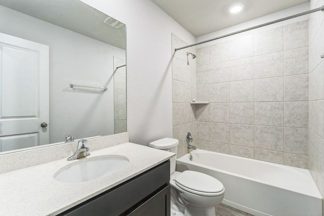 Bathroom with vanity, shower / bathtub combination, and wood finished floors | Image 6
