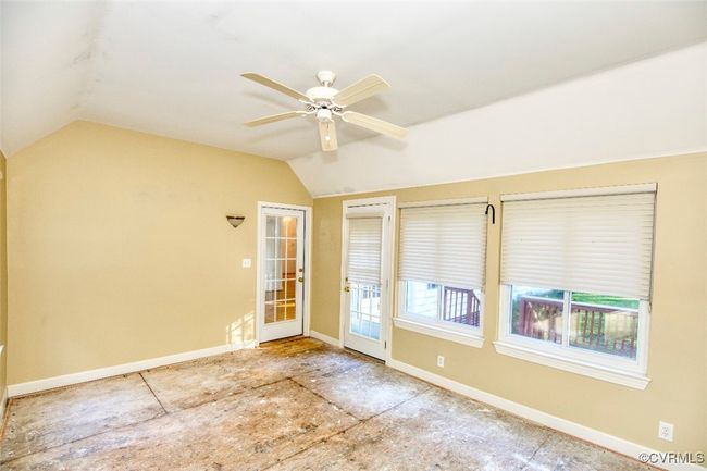 Unfurnished room featuring ceiling fan, lofted ceiling, and baseboards | Image 15