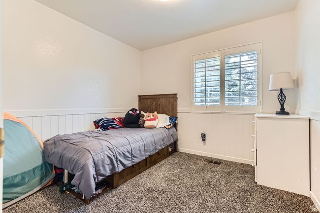 Bedroom with carpet and a wainscoted wall | Image 15