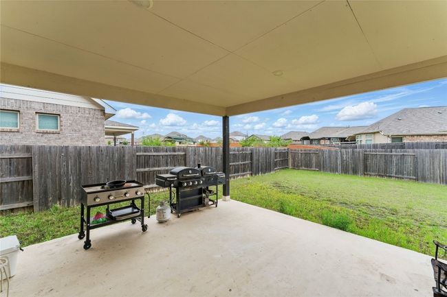 View of patio / terrace with a residential view, grilling area, and a fenced backyard | Image 32