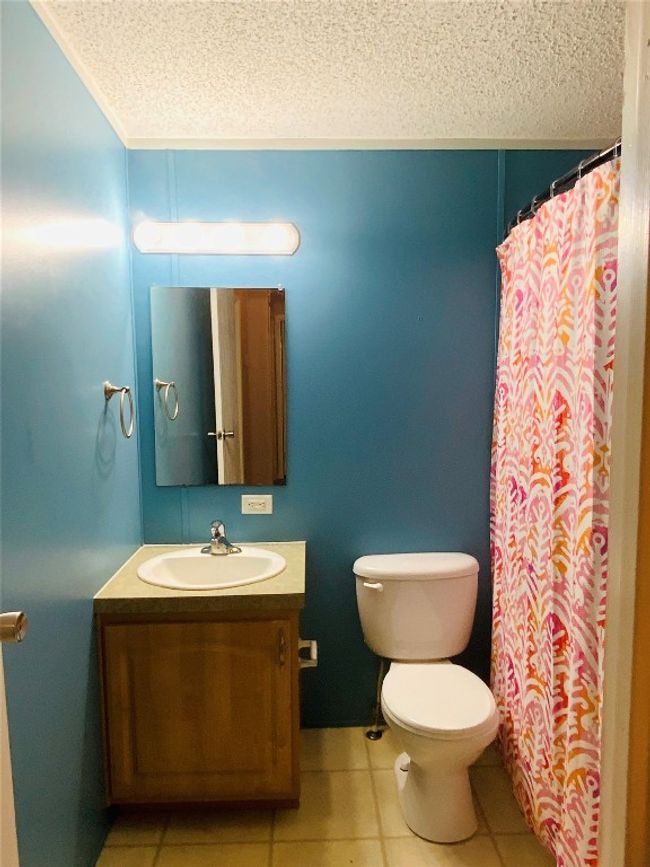 Full bath featuring tile patterned floors, vanity, and a textured ceiling | Image 27