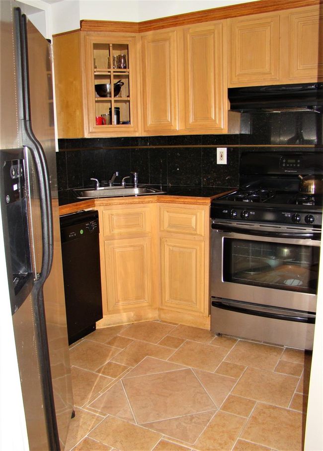 Kitchen featuring stainless steel appliances, sink, and backsplash | Image 5