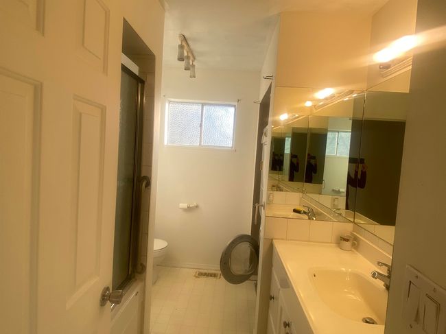 Bathroom featuring visible vents, toilet, plenty of natural light, and vanity | Image 8