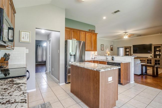 Kitchen with island. | Image 19