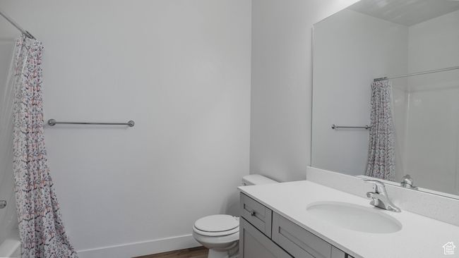 Bathroom with toilet, vanity, and wood finished floors | Image 18