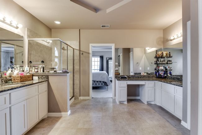 Bathroom featuring tile patterned floors, vanity, and a shower with door | Image 30
