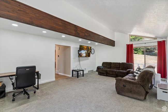 Living area featuring carpet, vaulted ceiling, an office area, and recessed lighting | Image 13