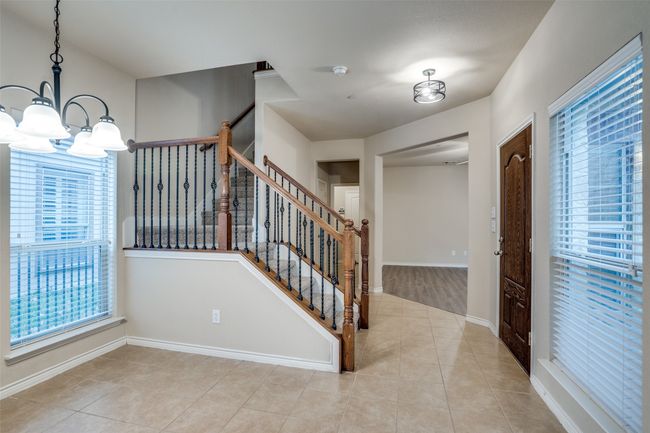 Stairs, decorative lighting, tile floors, and baseboards | Image 12