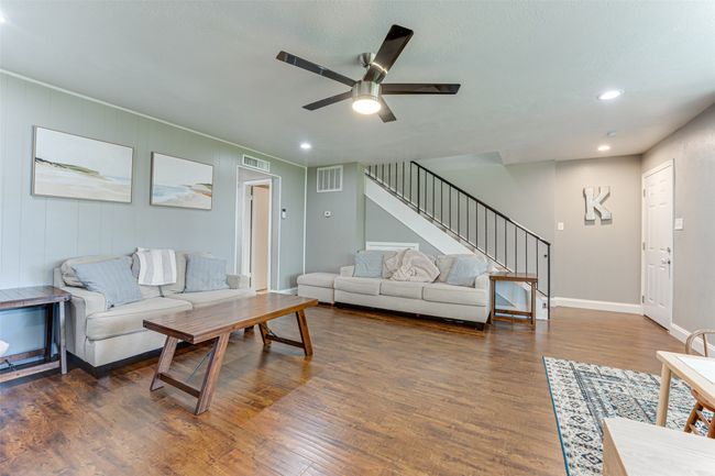 Living area with stairway, visible vents, and wood finished floors | Image 5