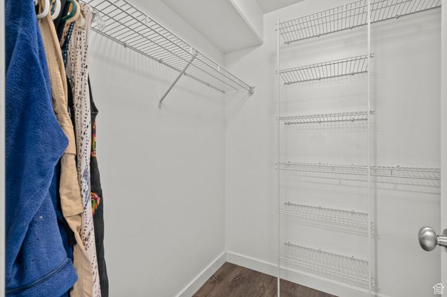 Spacious closet with dark wood finished floors | Image 25