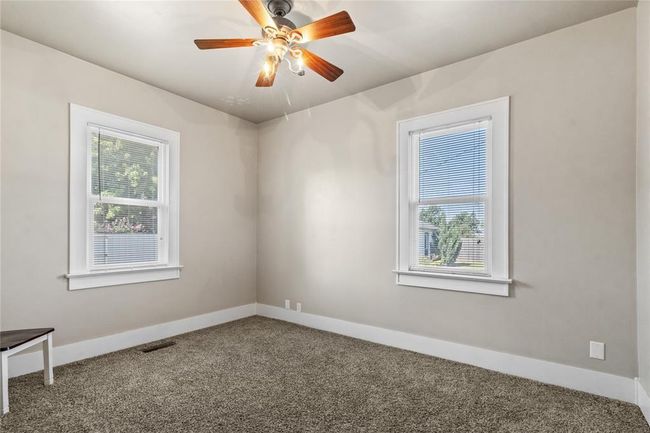 Carpeted spare room featuring visible vents, baseboards, and ceiling fan | Image 5