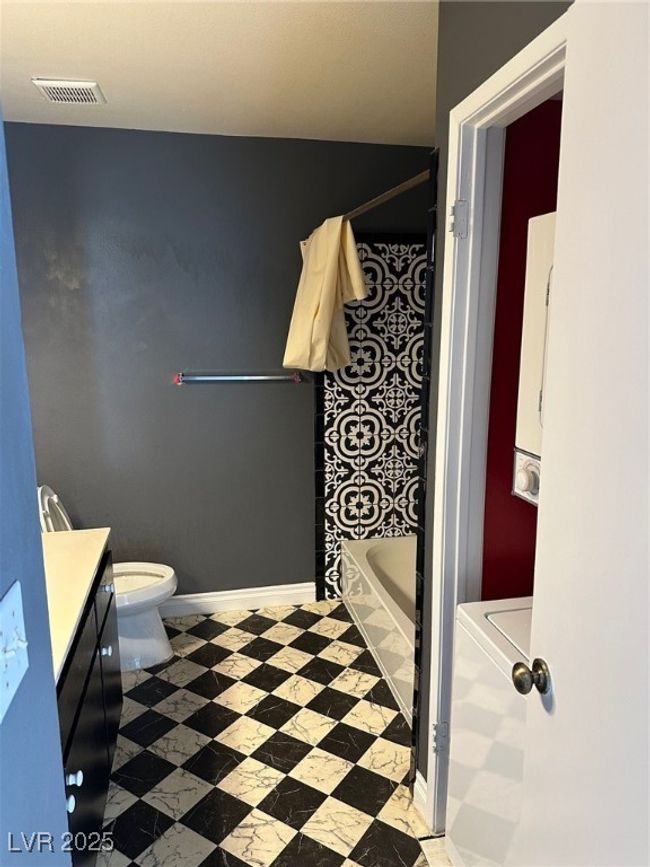 Bathroom featuring vanity and shower / bathtub combination with curtain | Image 5