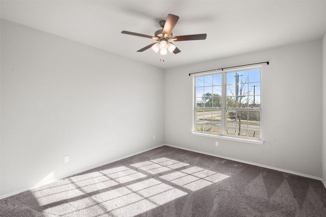 Carpeted empty room with baseboards and ceiling fan | Image 39