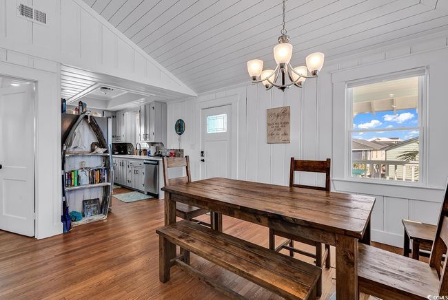 Dining area with an inviting chandelier, hardwood / wood-style floors, wood ceiling, and vaulted ceiling | Image 6