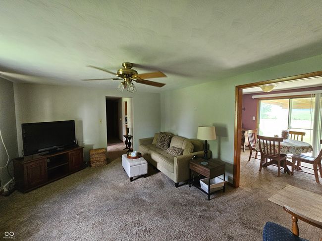dining area with carpet and crown molding | Image 16