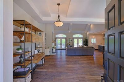 Entryway with beam ceiling, dark hardwood / wood-style flooring, and french doors | Image 3