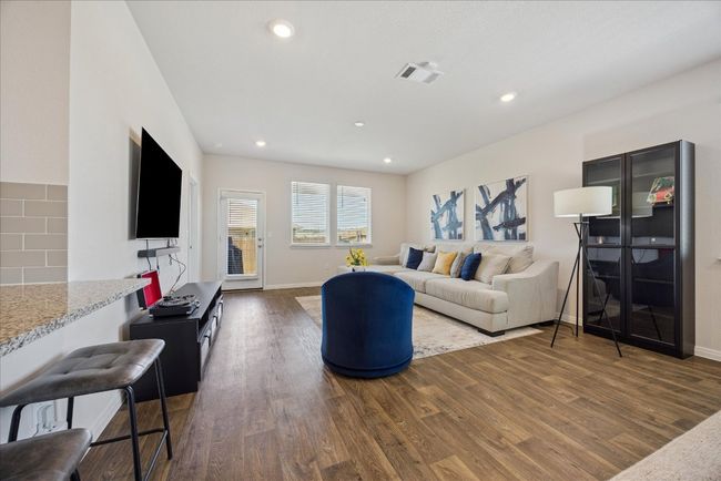 Living room with dark wood-type flooring and recessed lighting | Image 16