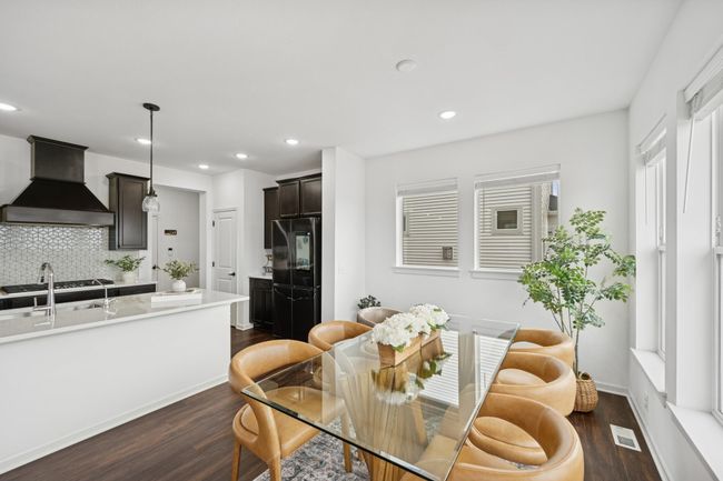 The dining room is bright with the large windows on two sides. | Image 13