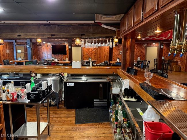 Community bar area with wood finished floors and wooden walls | Image 17