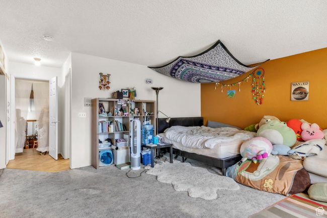 Bedroom featuring a textured ceiling and carpet | Image 19