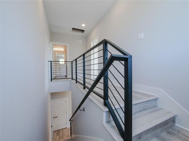 Stairway with wood finished floors and baseboards | Image 15