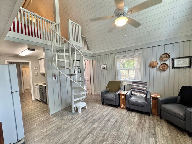 Living room with spiral stairs to loft bedroom | Image 10
