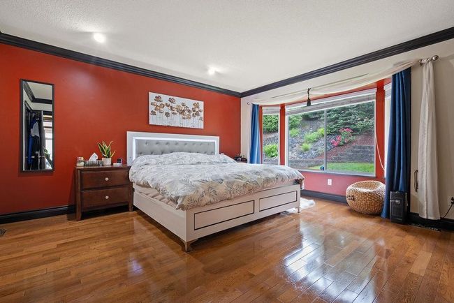 Bedroom featuring ornamental molding, wood finished floors, and baseboards | Image 20