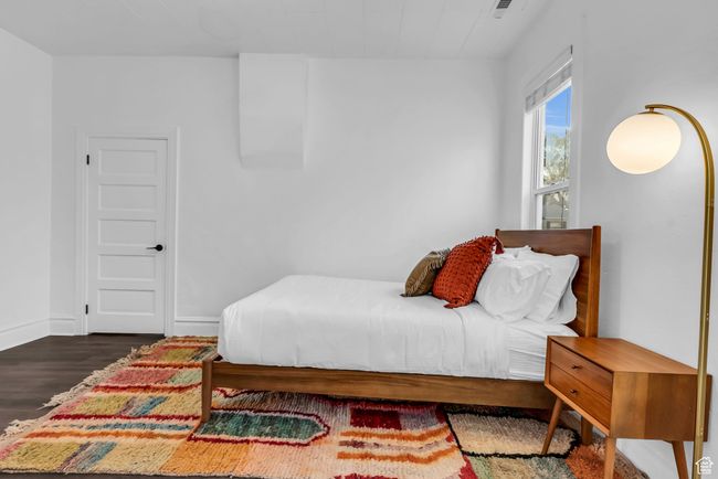 Bedroom with wood finished floors and baseboards | Image 9