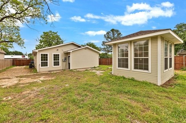 Back of house featuring an outdoor structure, a fenced backyard, and a lawn | Image 28