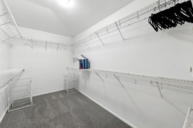 Home office with baseboards, a ceiling fan, wood finished floors, and visible vents | Image 30
