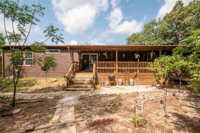 View of back of home featuring a covered deck | Image 28