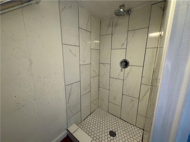 Full bathroom featuring a tile shower | Image 23