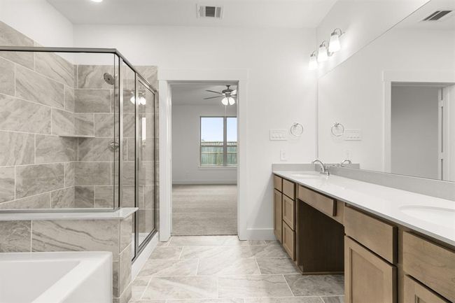 Enjoy the privacy of a well-appointed primary bath in your suite | Image 16