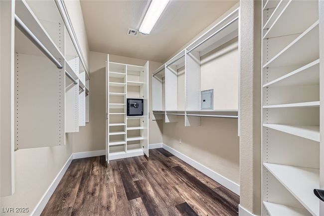 Spacious closet featuring dark wood-type flooring and electric panel | Image 24