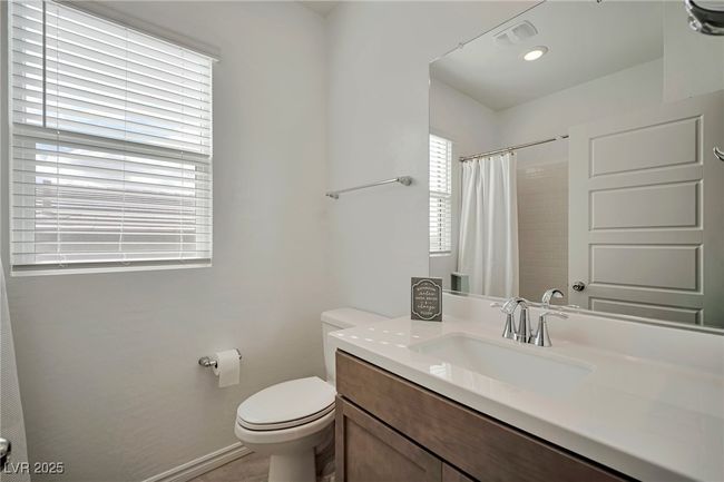 Full bathroom with visible vents, baseboards, toilet, curtained shower, and vanity | Image 27