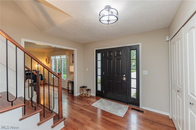 Foyer featuring a textured ceiling and hardwood / wood-style flooring | Image 2