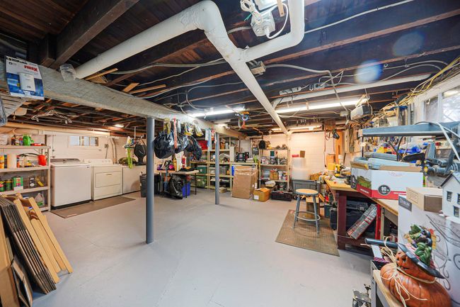 Below grade area featuring independent washer and dryer and a workshop area | Image 22