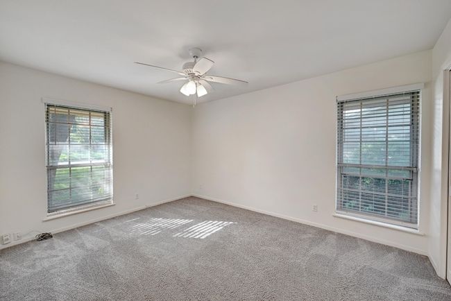 Empty room featuring carpet flooring, baseboards, and a ceiling fan | Image 21