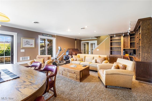 Carpeted living room with recessed lighting, a healthy amount of sunlight, crown molding, and visible vents | Image 42